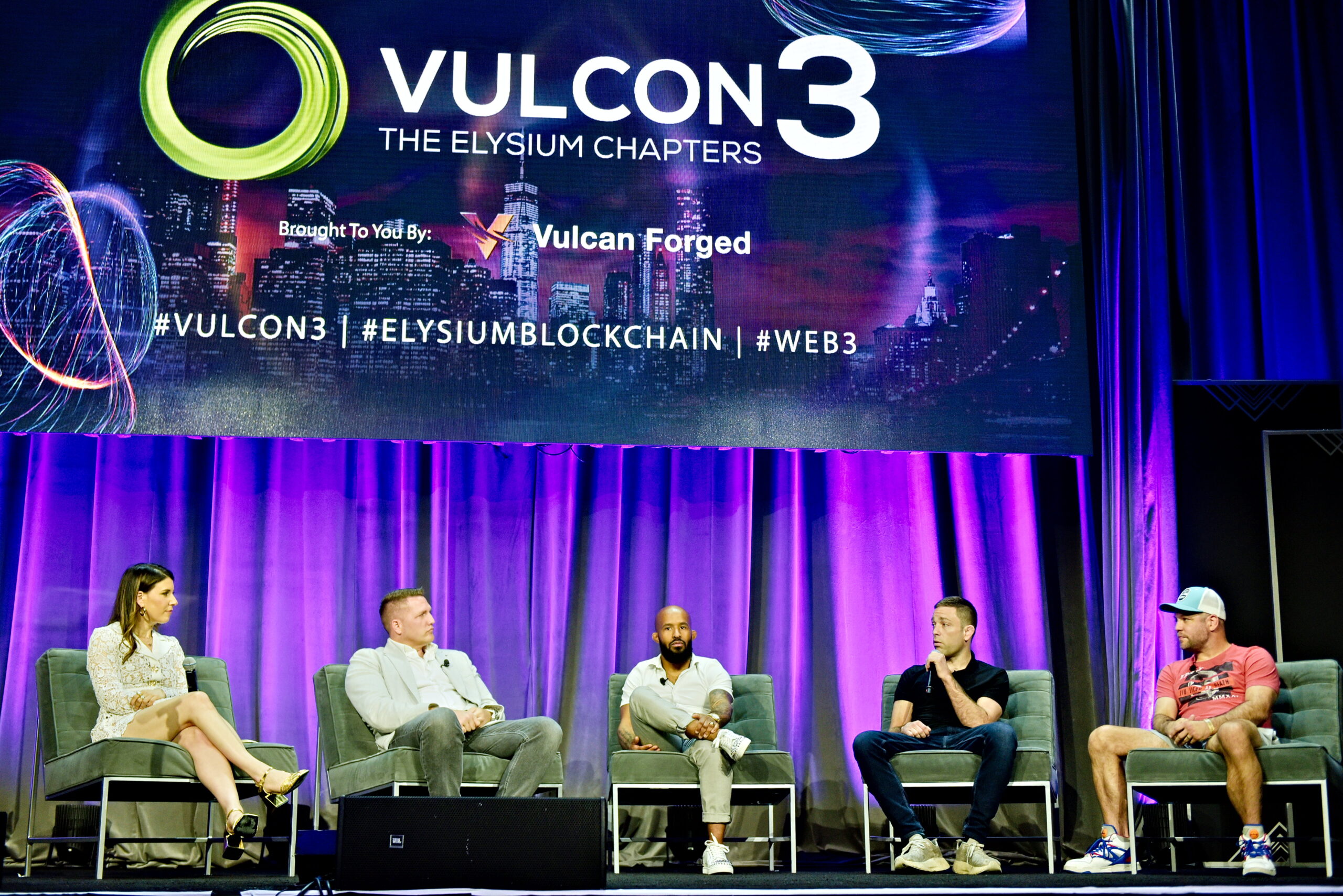 Demetrious Johnson, Ryan Hall and Brandon McCaghran on stage at Vulcan Forged's VulCon3 in New York City, May 2023 forming an MMA Vulcan Fight League panel. Also present at Jamie Thomson and Anna Roisman.